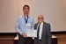 Dr. Nagib Callaos, General Chair, giving Dr. Kevin E. Foltz the best paper award certificate of the session "Information Systems, Technologies and Applications I." The title of the awarded paper is "Managing Information Security System Technology Changes Across an Enterprise."